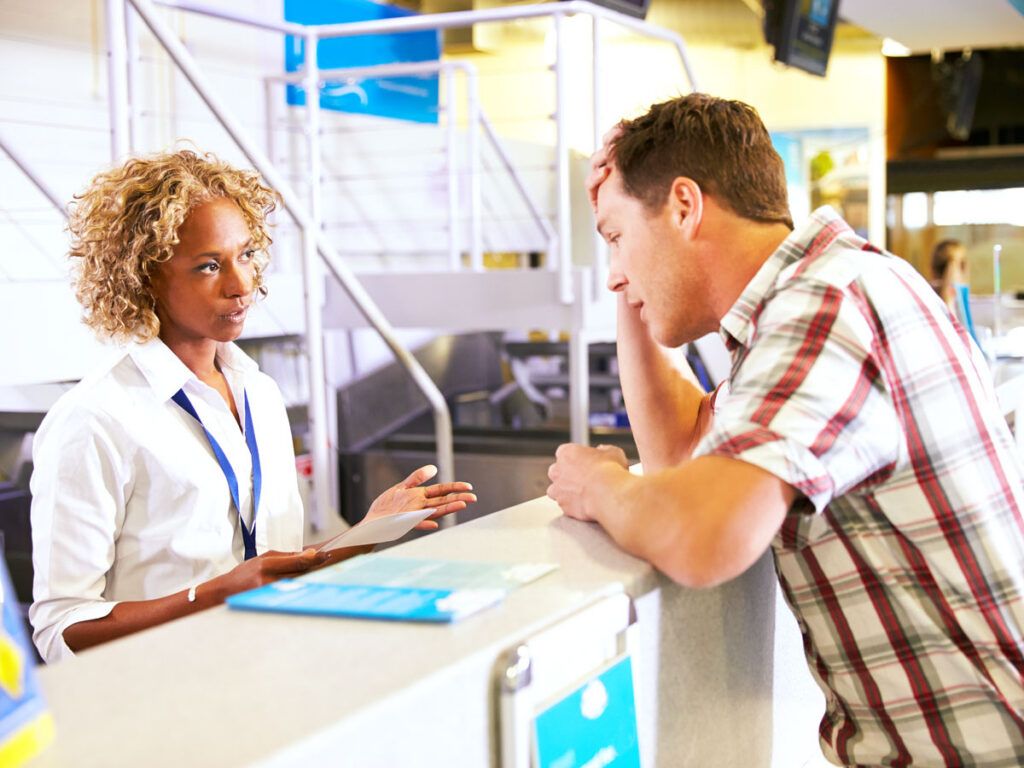 Passenger speaking to airline employee