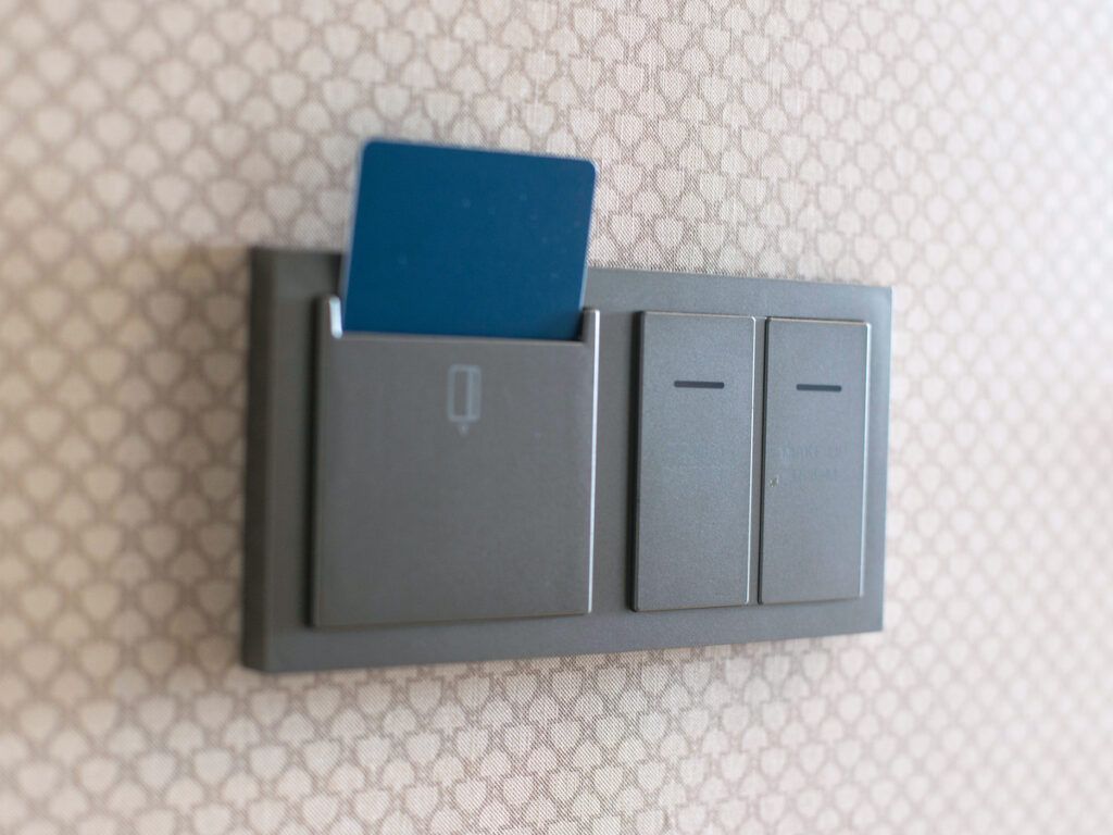Hotel room key card in slot on wall