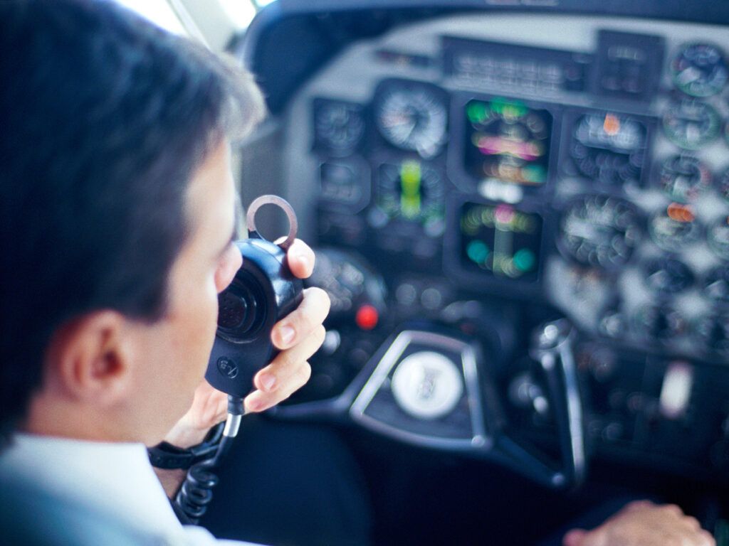 Airline pilot communicating over radio