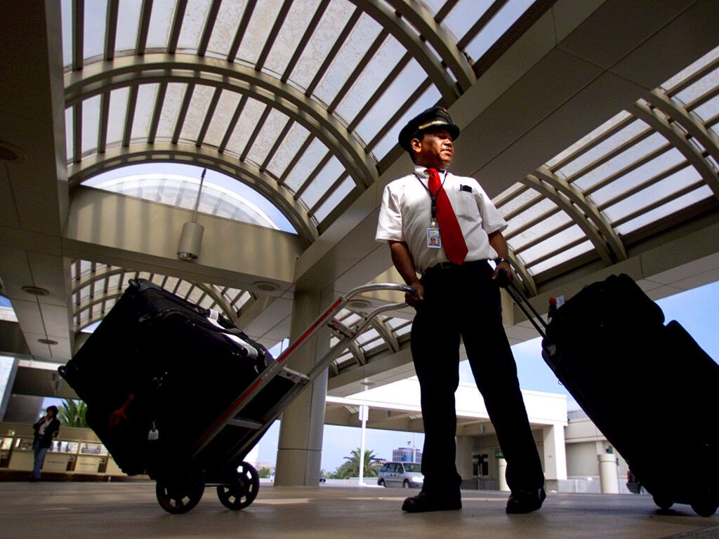 Airport skycap with luggage