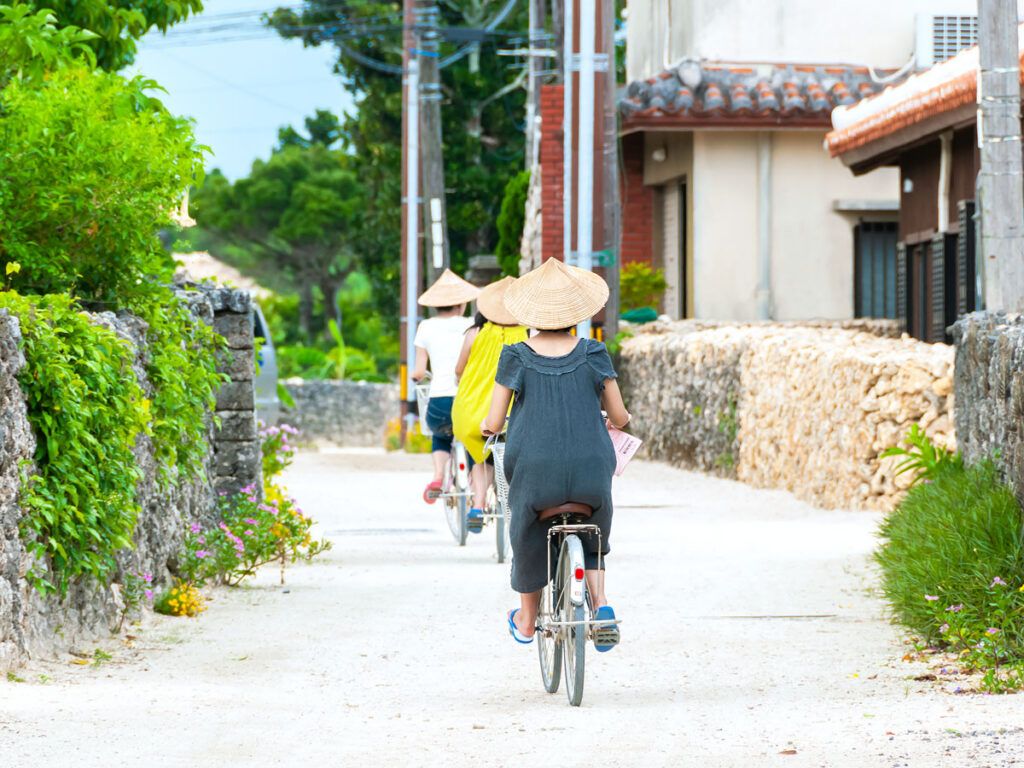 People riding bikes on Taketomi Island in Japan