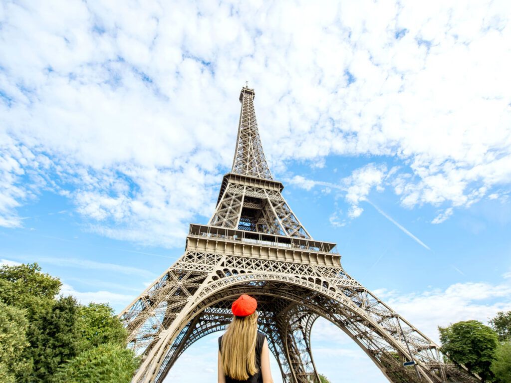 Tourist gazing up at Eiffel Tower