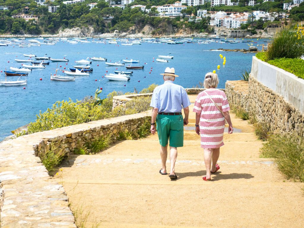 Couple walking down steps in seaside port city in Spain