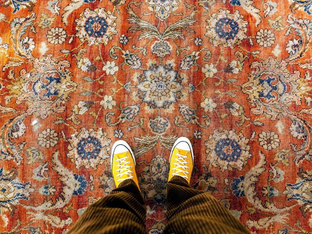Person standing on patterned rug