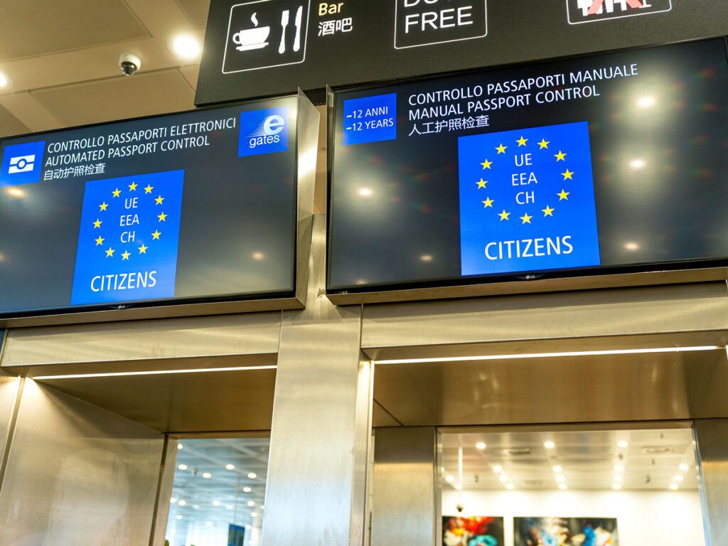 Signs at passport control checkpoint in airport