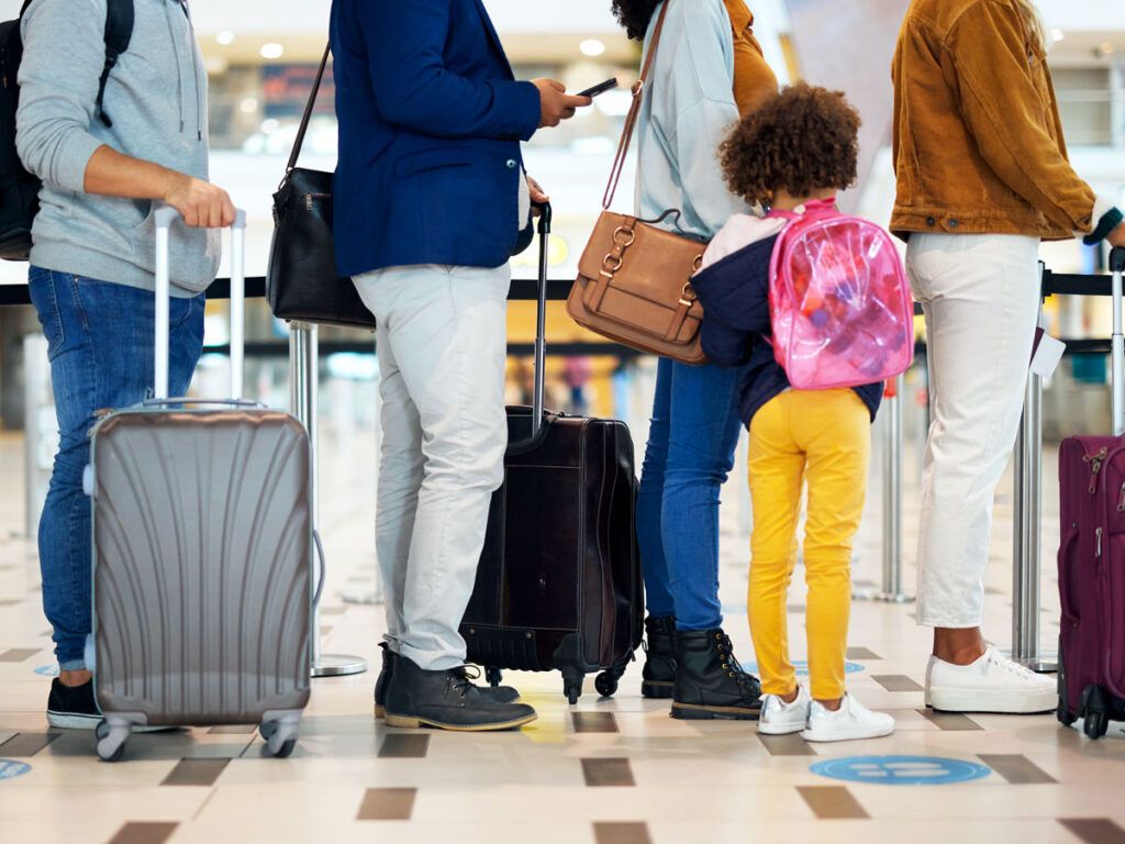 Travelers standing in queue at airport