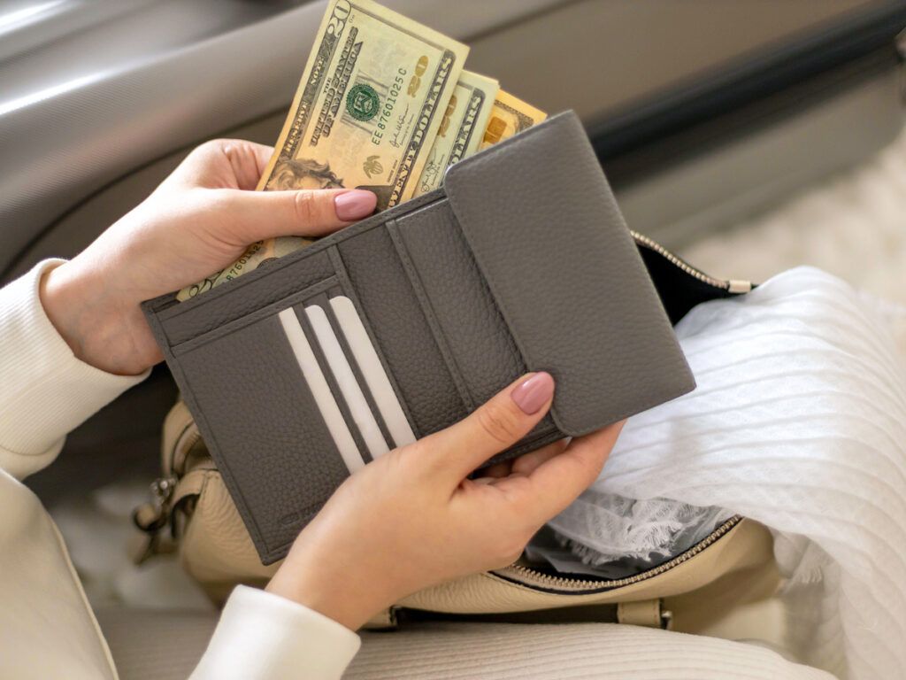 Person taking dollar bills out of wallet