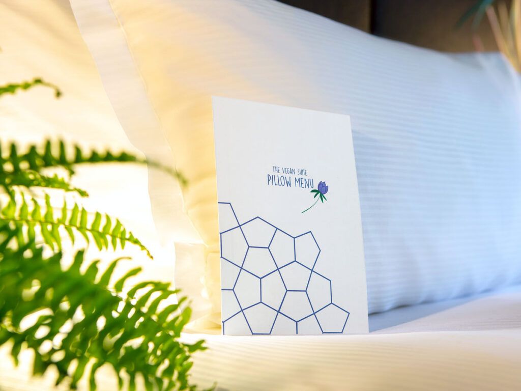 Pillow menu resting on hotel bed