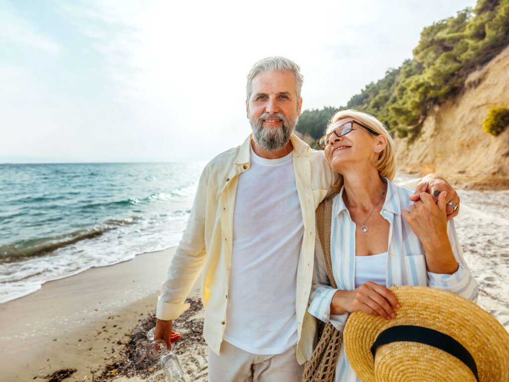 Couple walking on beach arm-in-arm