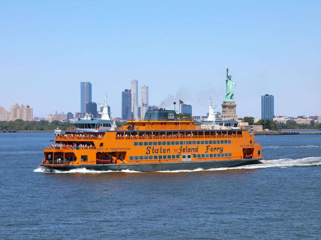 Staten Island Ferry sailing past Statue of Liberty