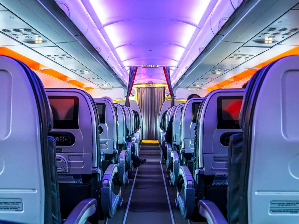 View of economy-class cabin toward front of plane