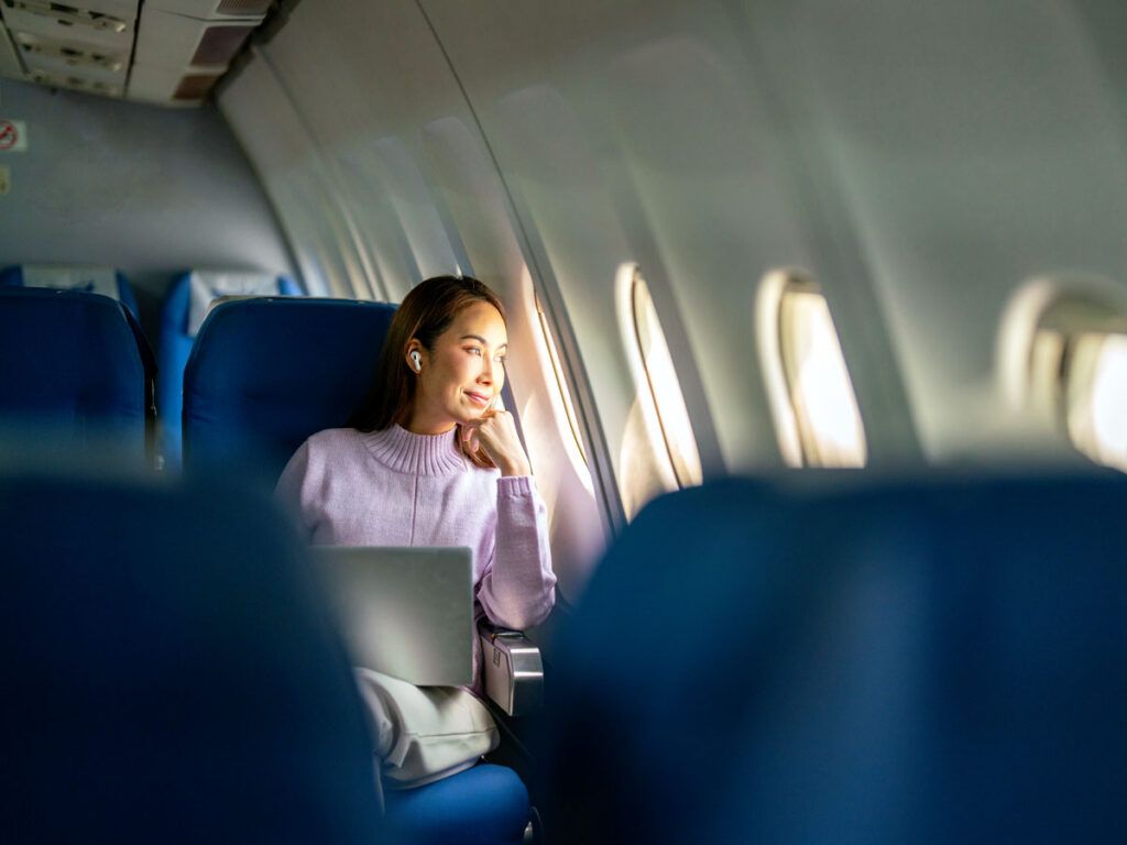 Passenger looking out airplane window