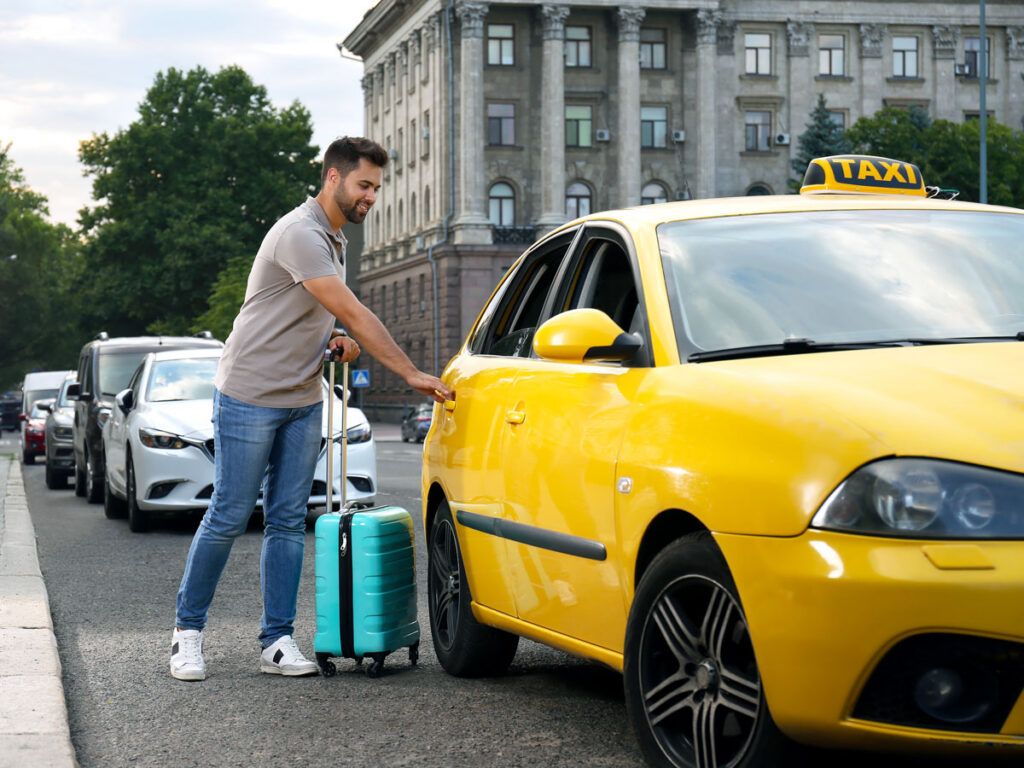 Traveler stepping into taxi