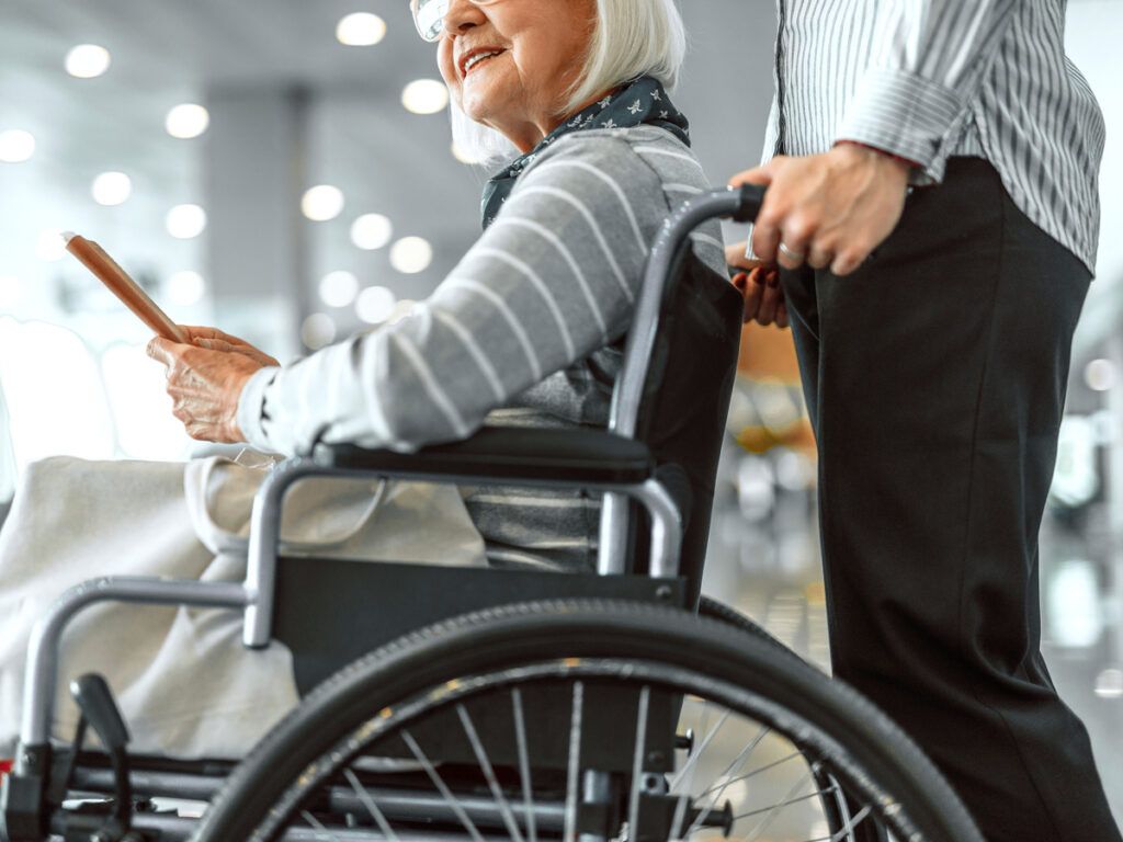 Passenger in wheelchair in airport terminal