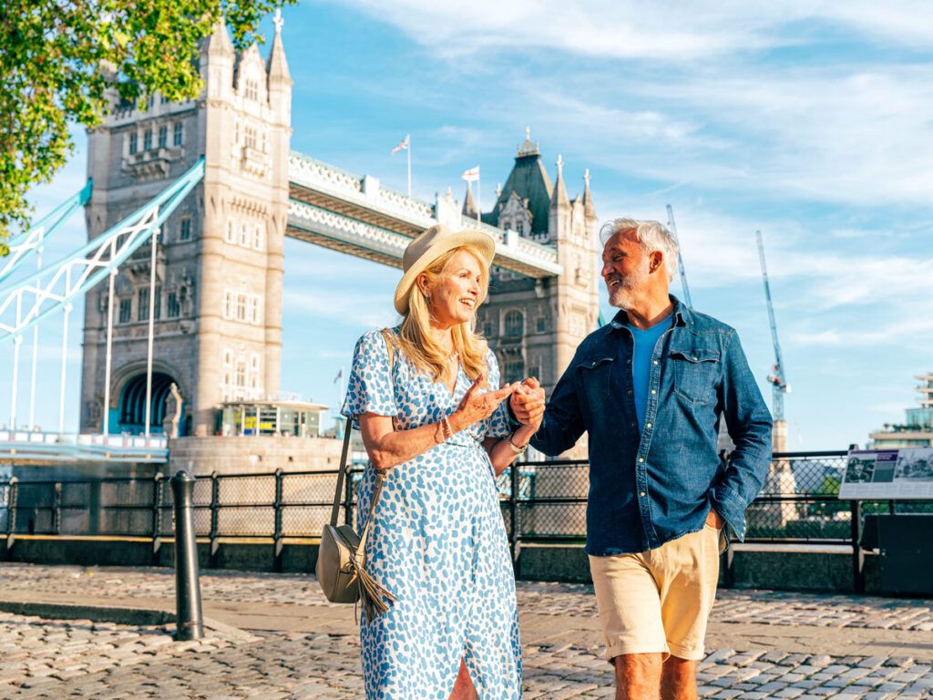 Couple walking in front of Tower Bridge in London, England