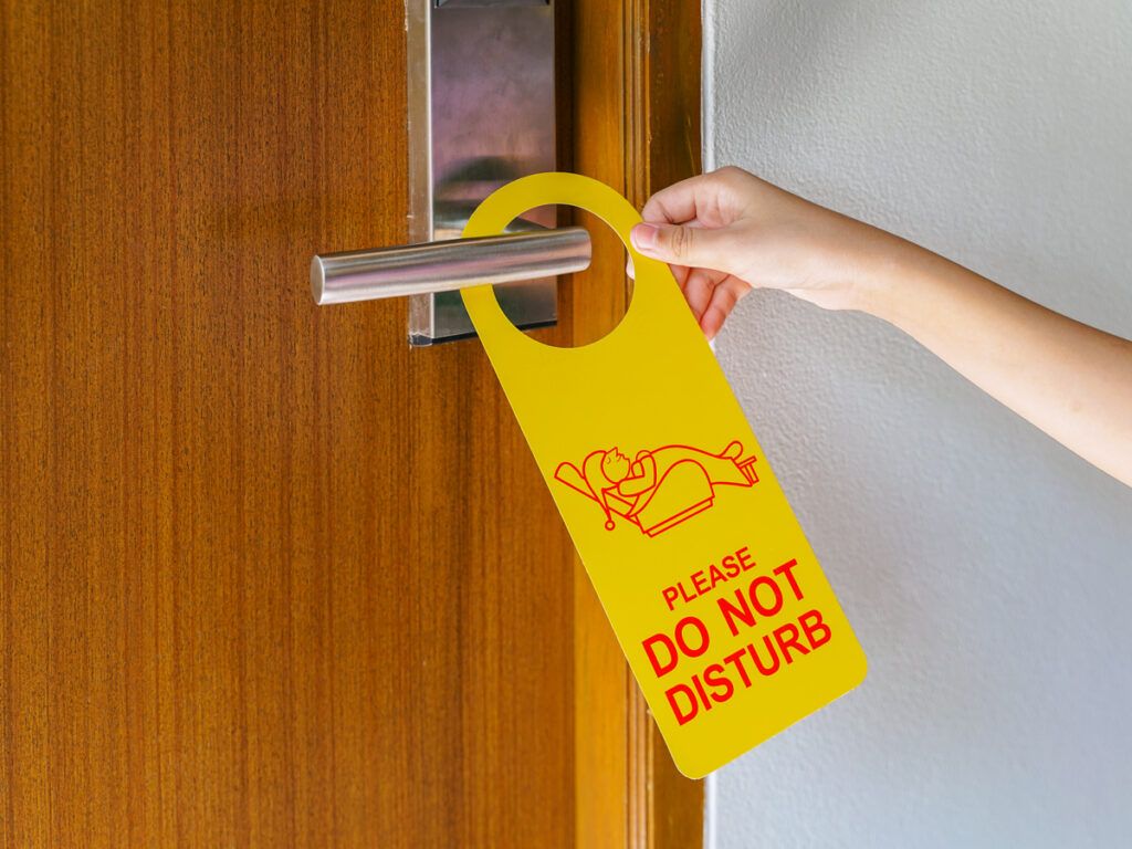 "Do not disturb" sign on hotel room door