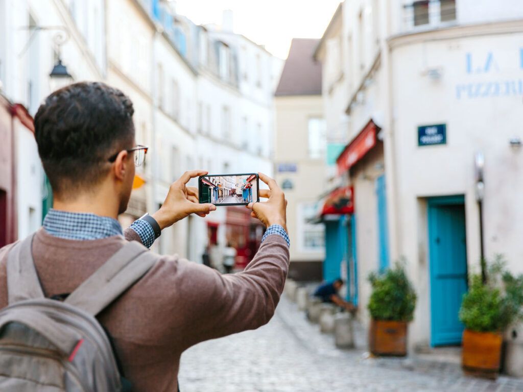 Tourist taking photo with smartphone