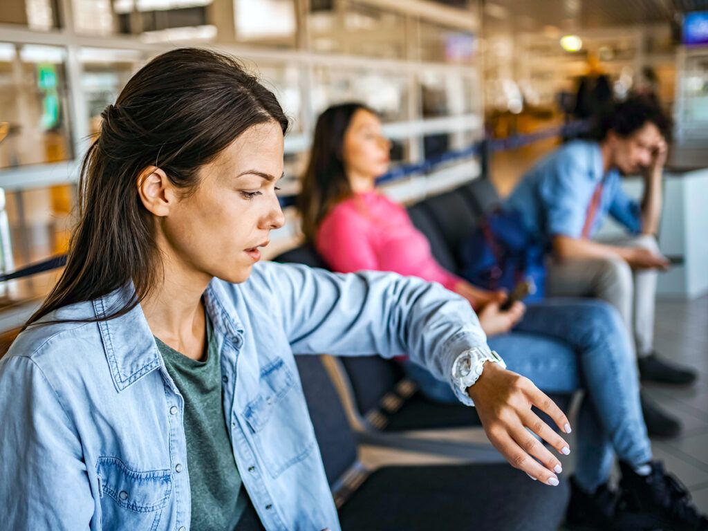 Passenger checking watch in airport terminal