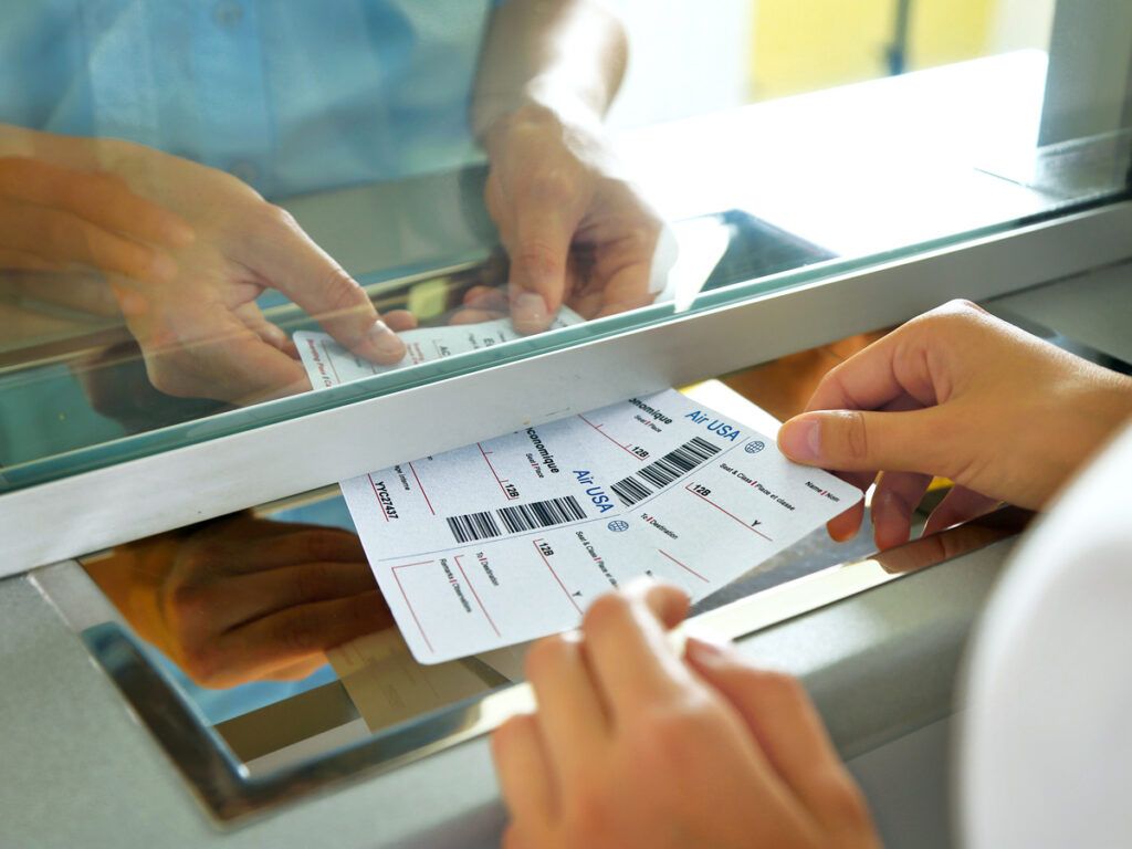 Agent handing passenger paper boarding passes