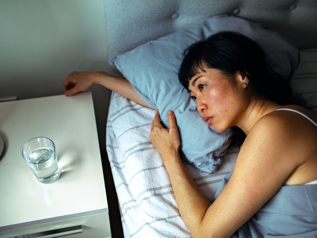 Woman lying awake in bed
