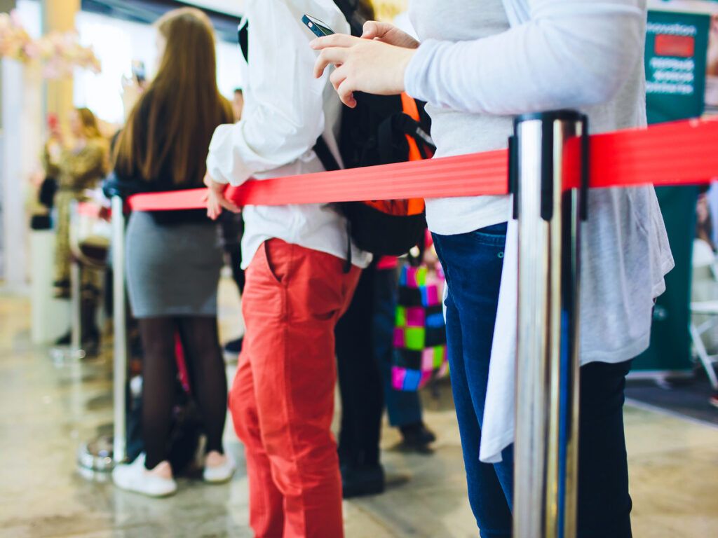 Passengers waiting in a long security line at the airport
