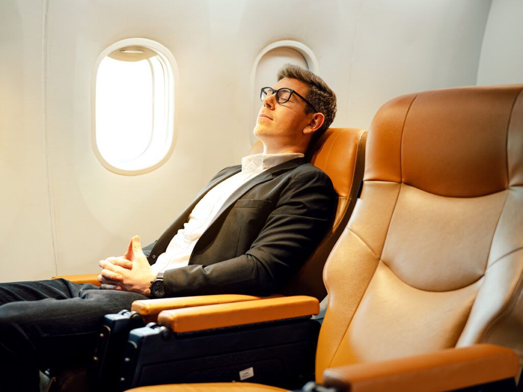 Traveler reclining in airplane seat