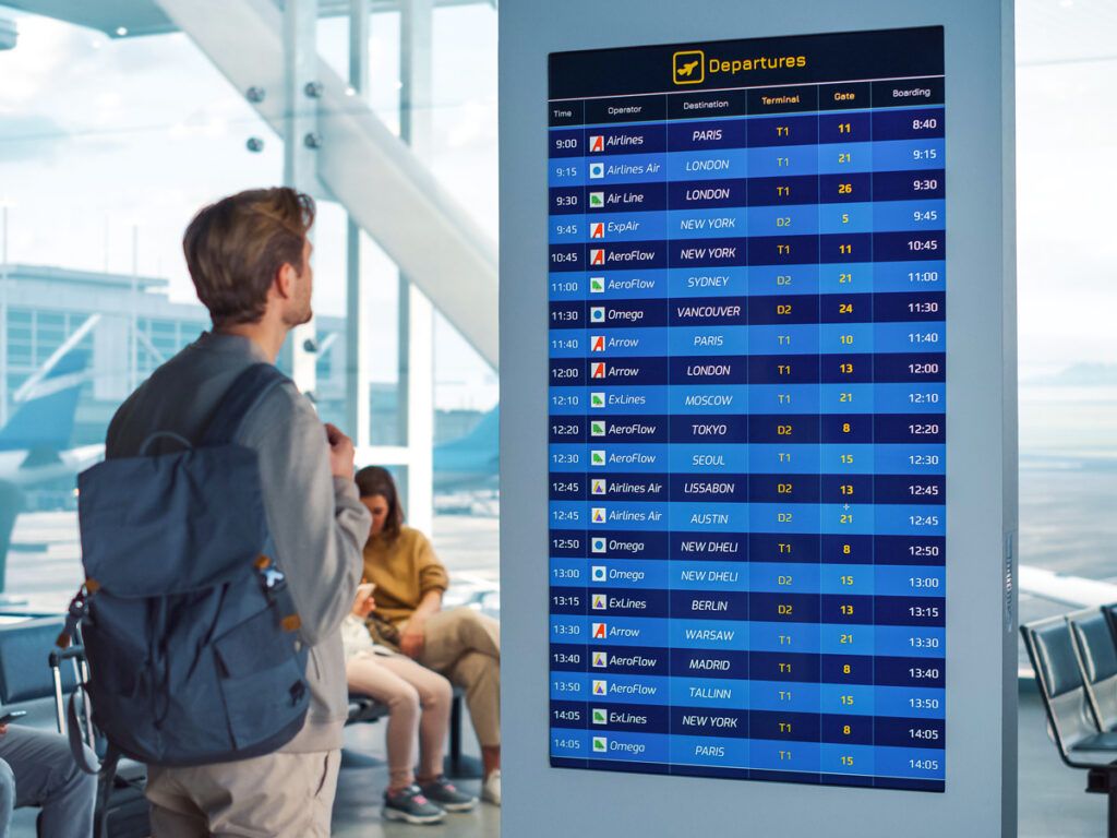 Airline passenger looking at departures board