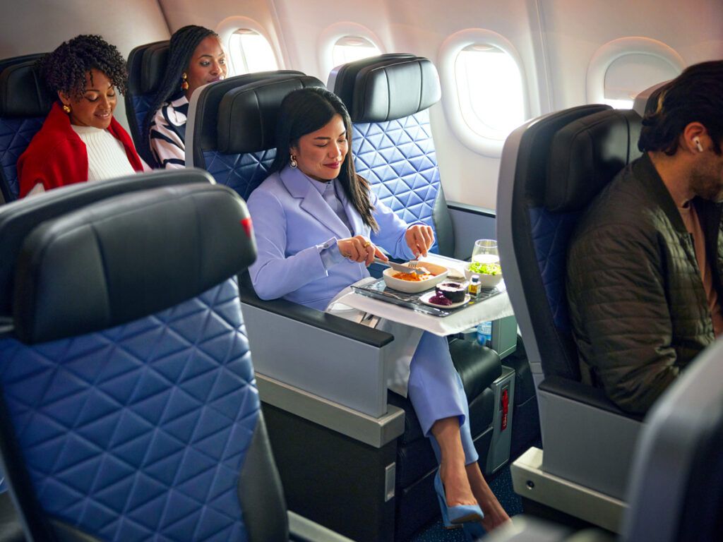Passenger eating meal in Delta's Premium Select cabin