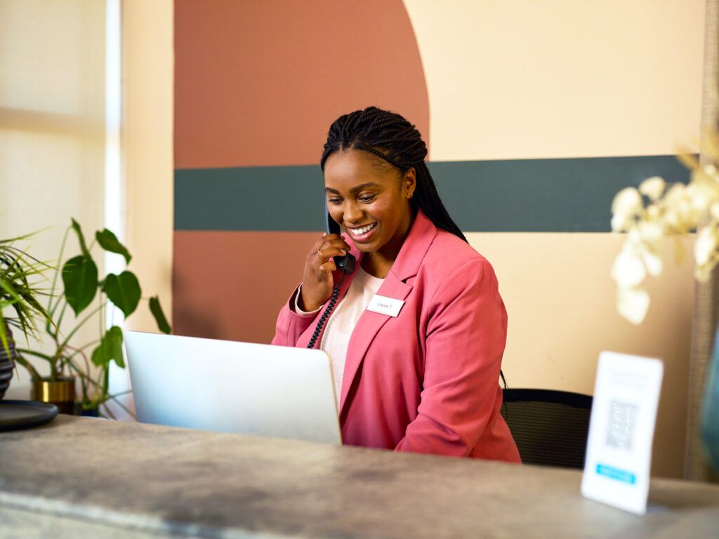 Receptionist talking on phone at desk