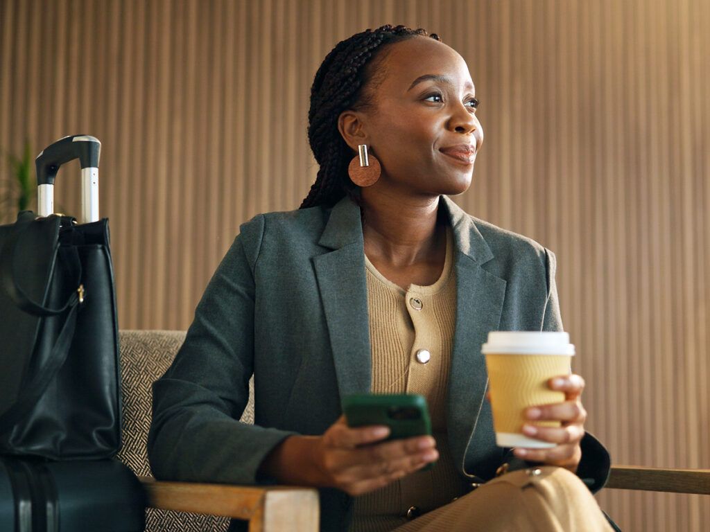 Woman drinking coffee in airport lounge