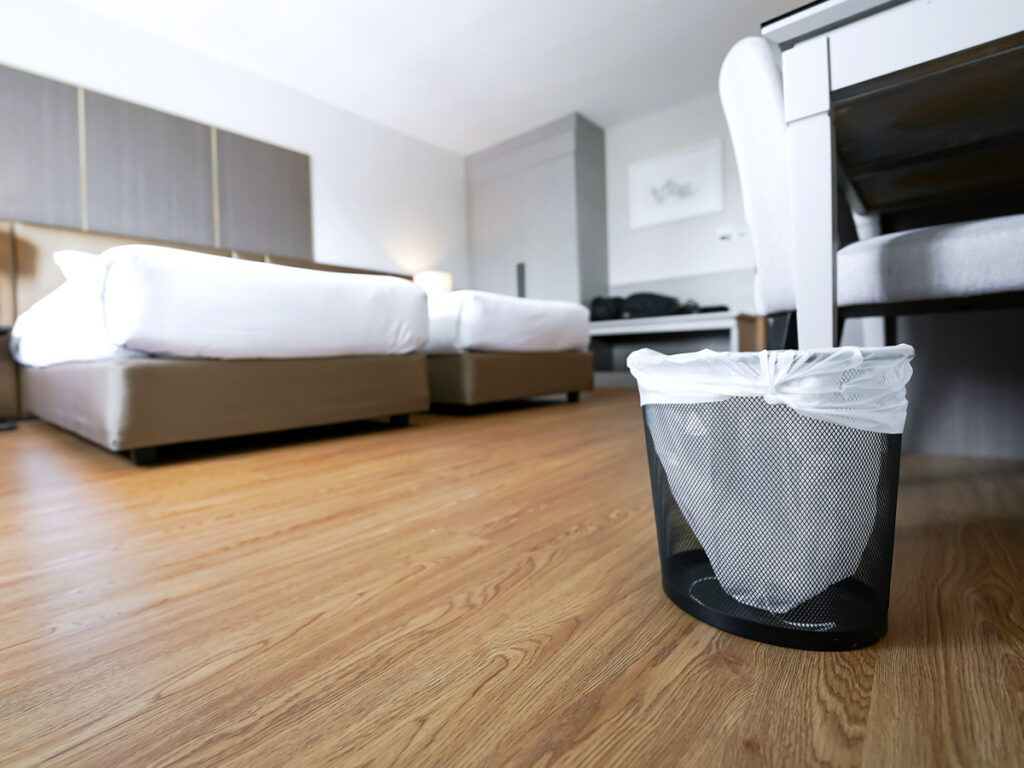 A trash can in a hotel room