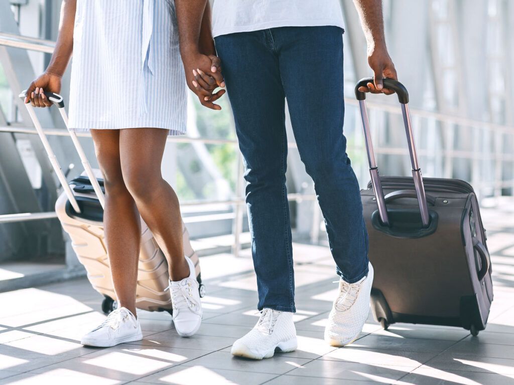 Couple traveling with luggage at airport