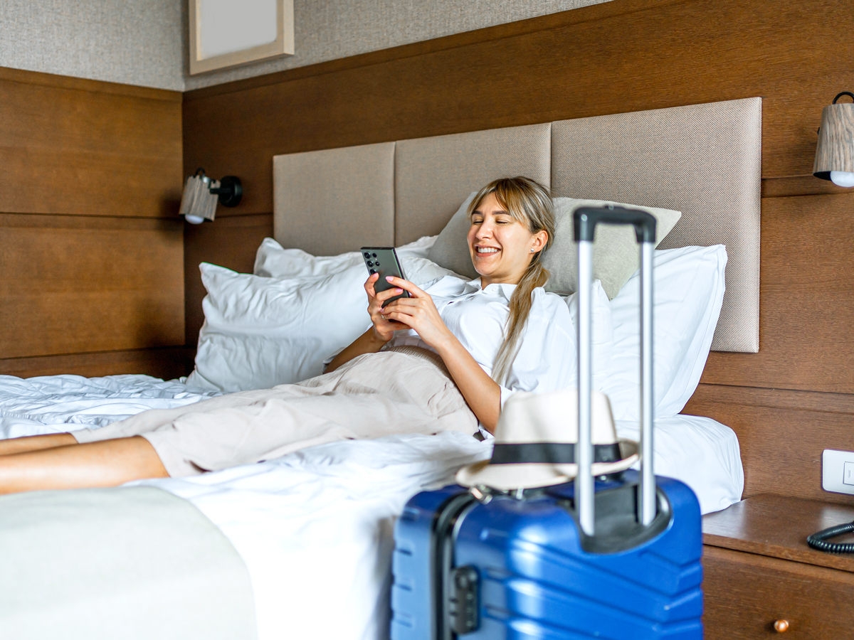 Woman using the phone in a hotel room
