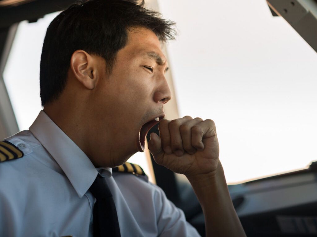 A tired pilot yawns