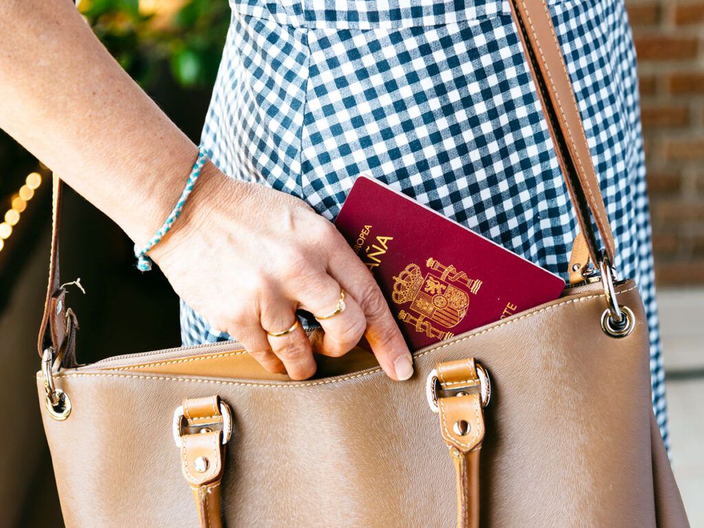 Woman taking a Spanish passport out of her purse