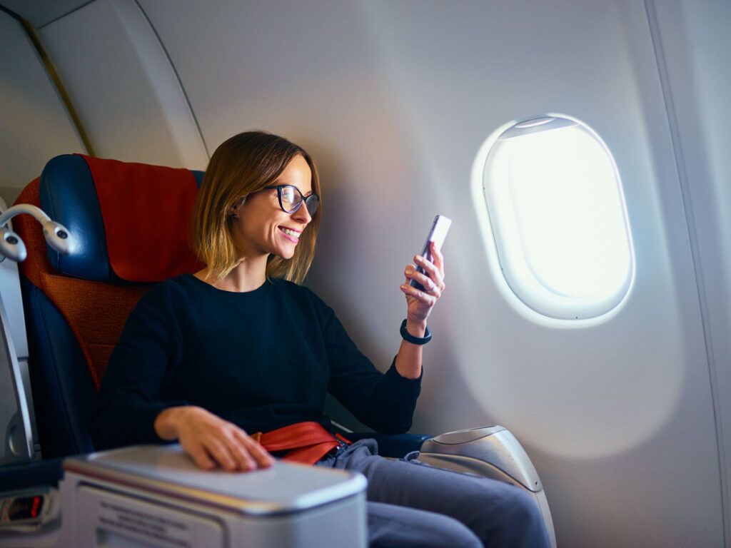Woman using a phone during a flight