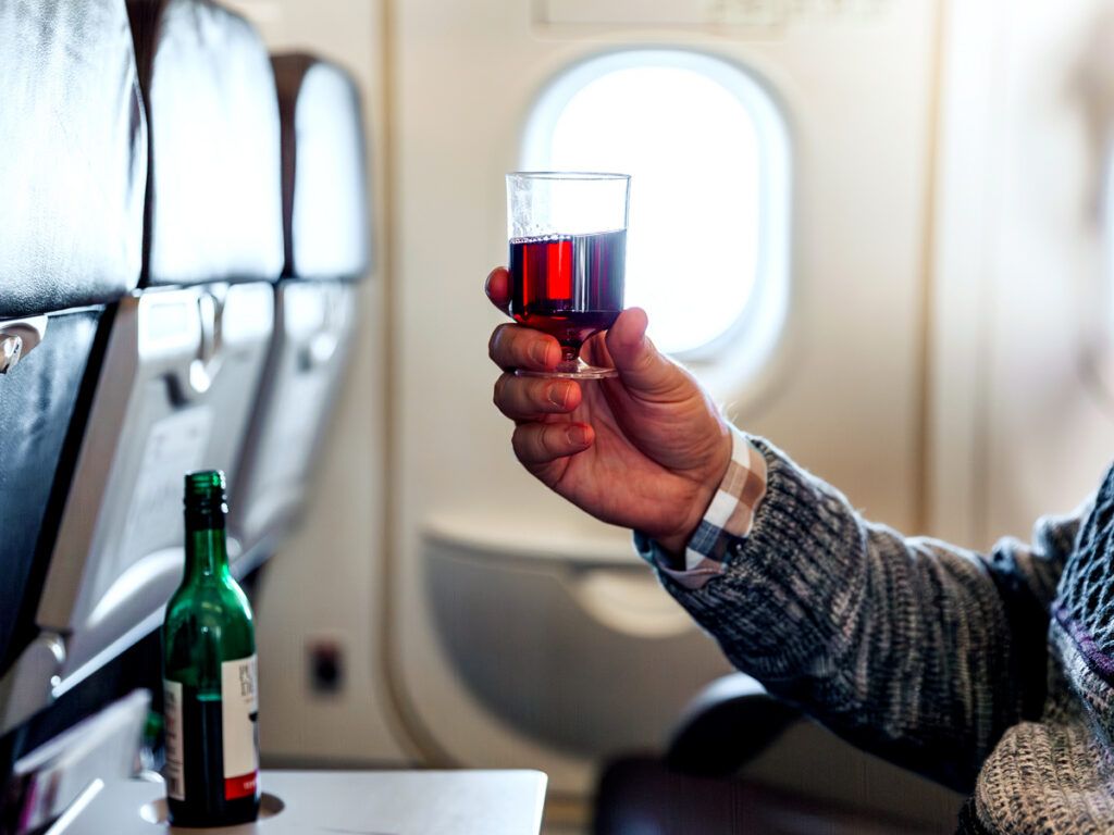 Man drinking red wine from a plastic wine glass