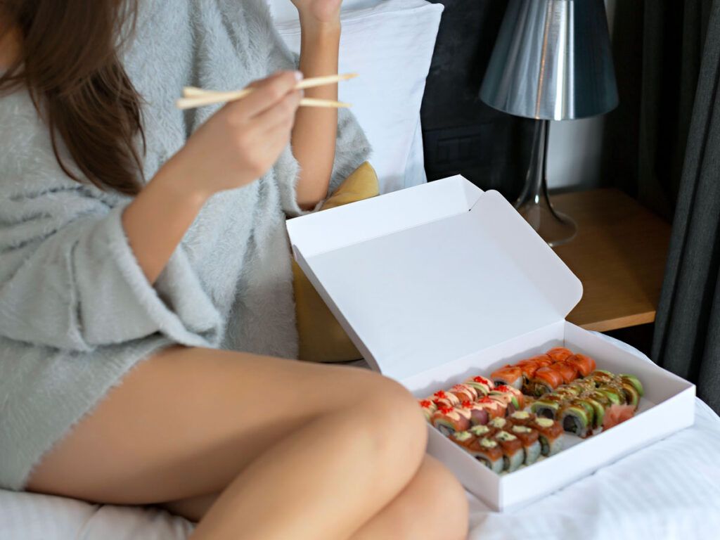 Woman eating sushi rolls