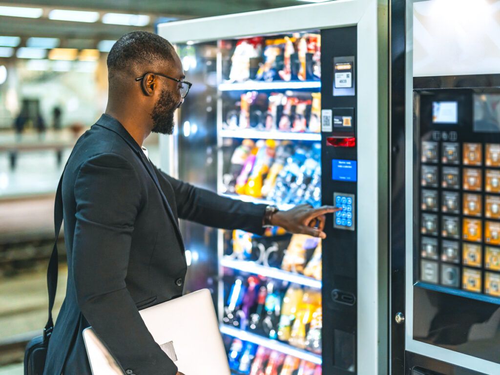 Businessman buying from a vending machine