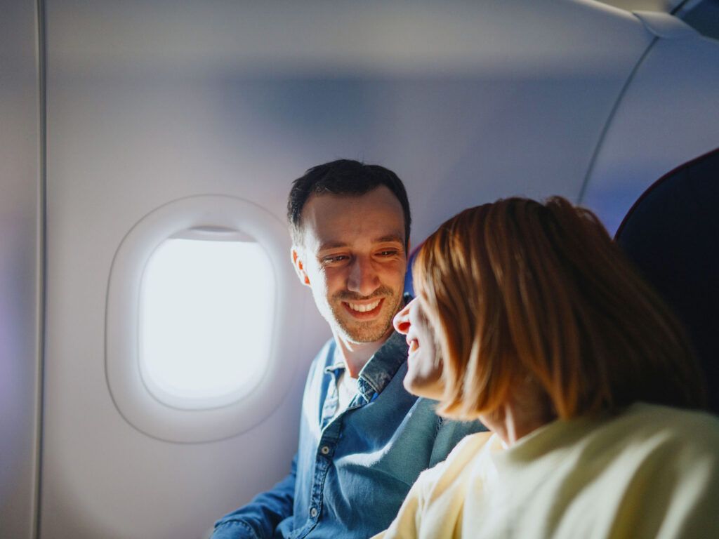 Passengers enjoying the window seat on a flight