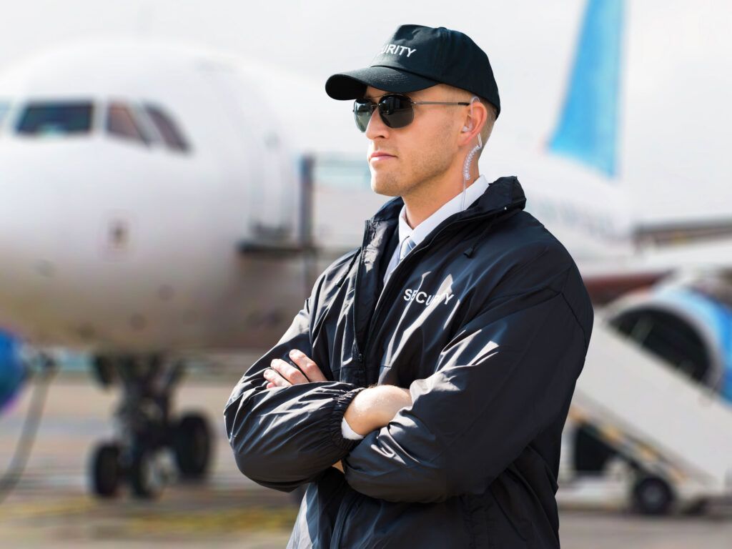 Security guard in front of a plane