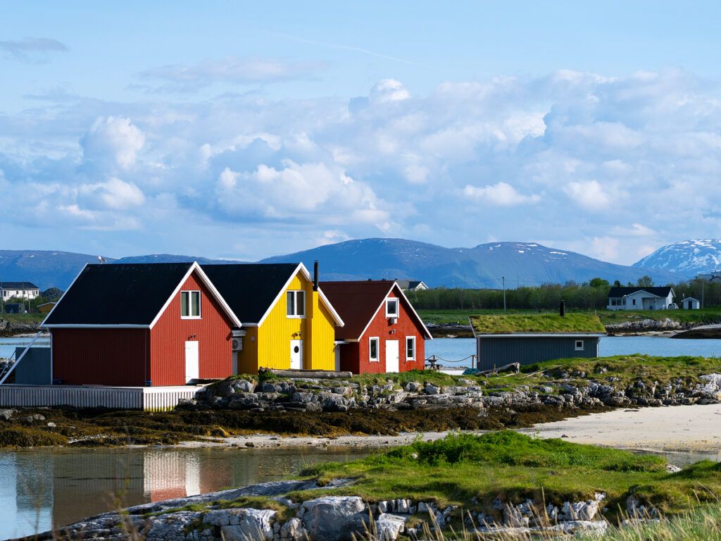 Three iconic, side-by-side colorful houses on the island of Sommarøy, Norway