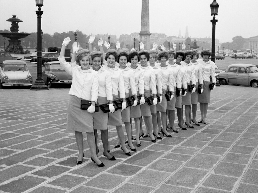 Trans World Airlines flight attendants wave in unison at the Place de la Concorde in Paris, France