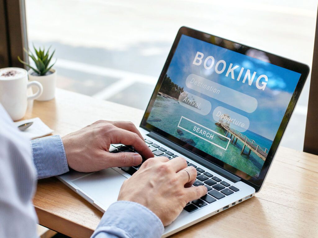 Person booking a trip online from a laptop