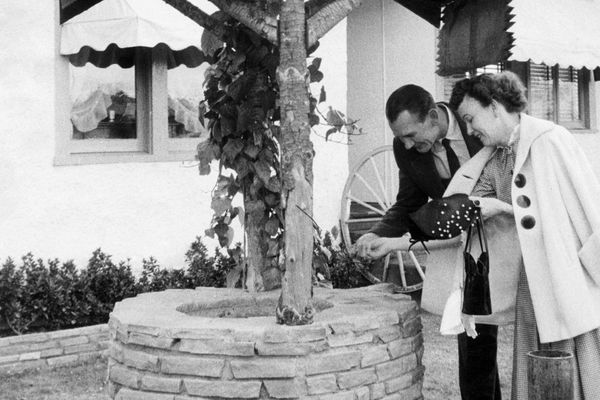 Couple throws coin in well, c. 1962