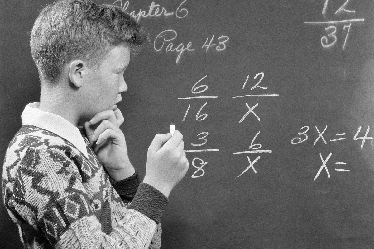 Boy solving math problem, 1950s