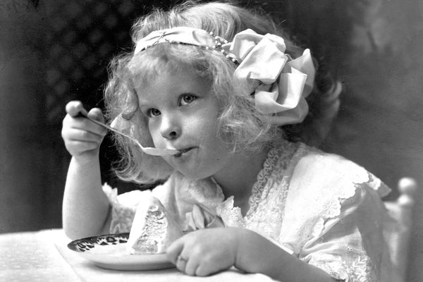 Little girl eating ice cream, 1913