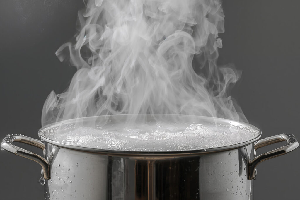 A black and white image of steam rising from a boiling pot of water.
