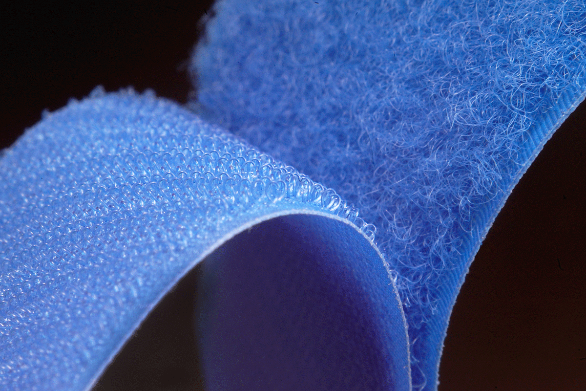 Two ends of Velcro peeling from one another