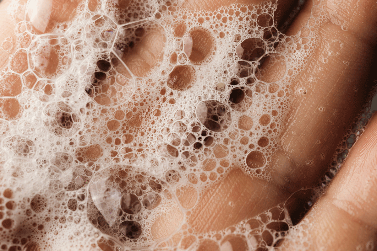 Soapy suds on a wet hand